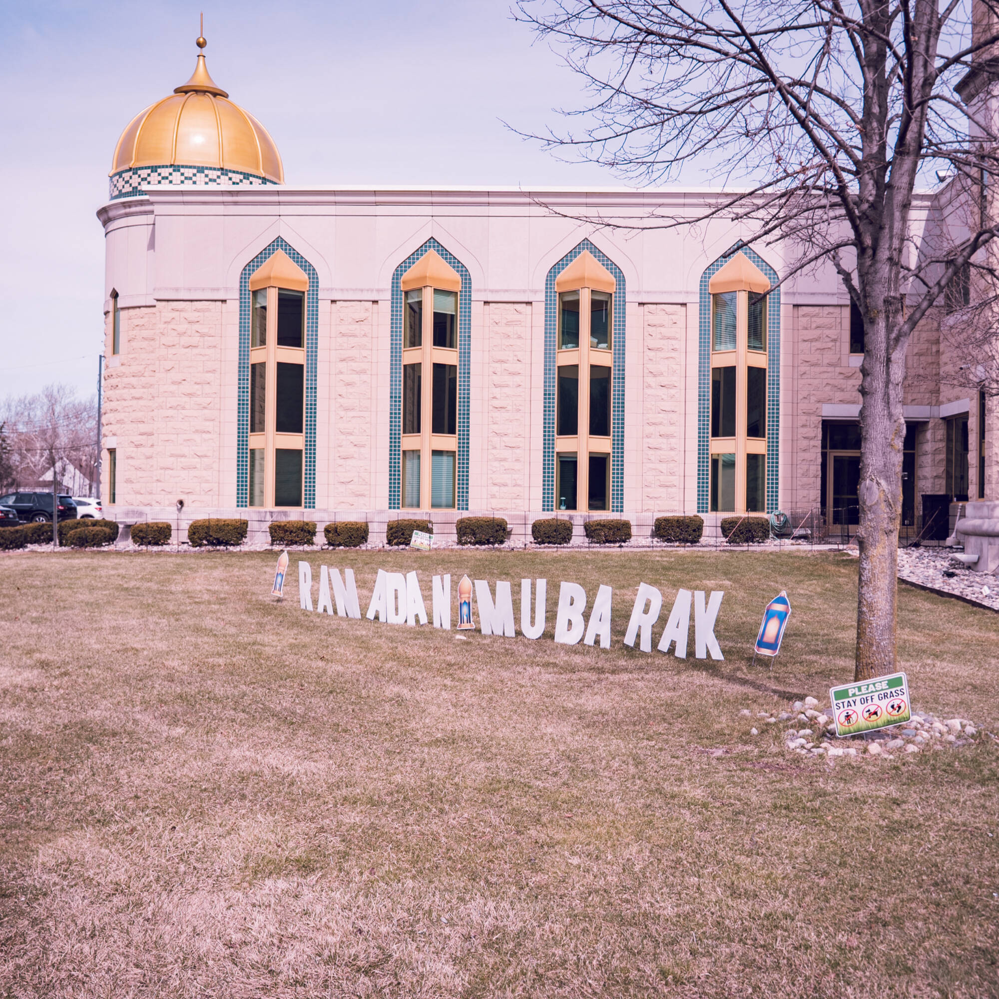 The outside of the masjid with yard signs spelling out "Ramadan Mubarak"